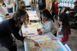 Photo by Jade Code: Mara Mintzer, GUB Director, listen to 2nd grade students' input for the country's first, printed child-friendly city map.